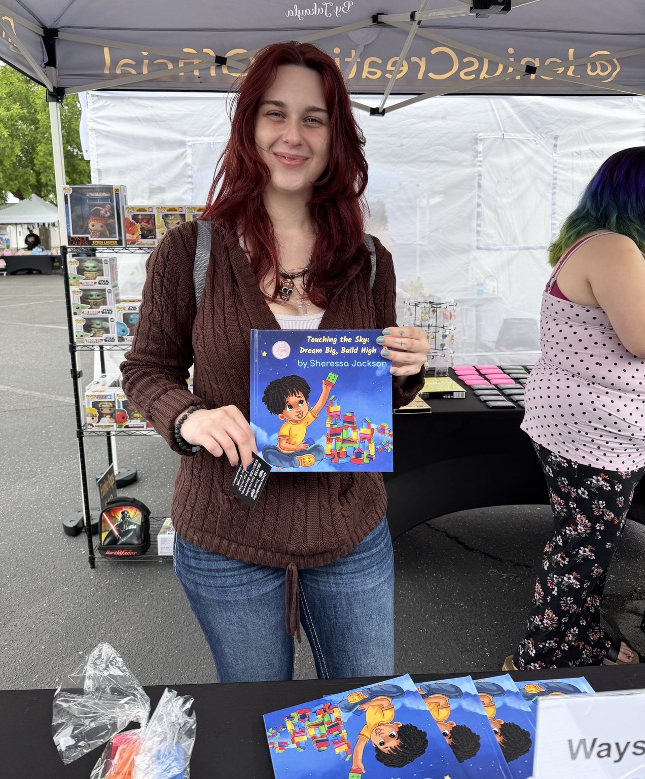 Community reader holding Touching the Sky