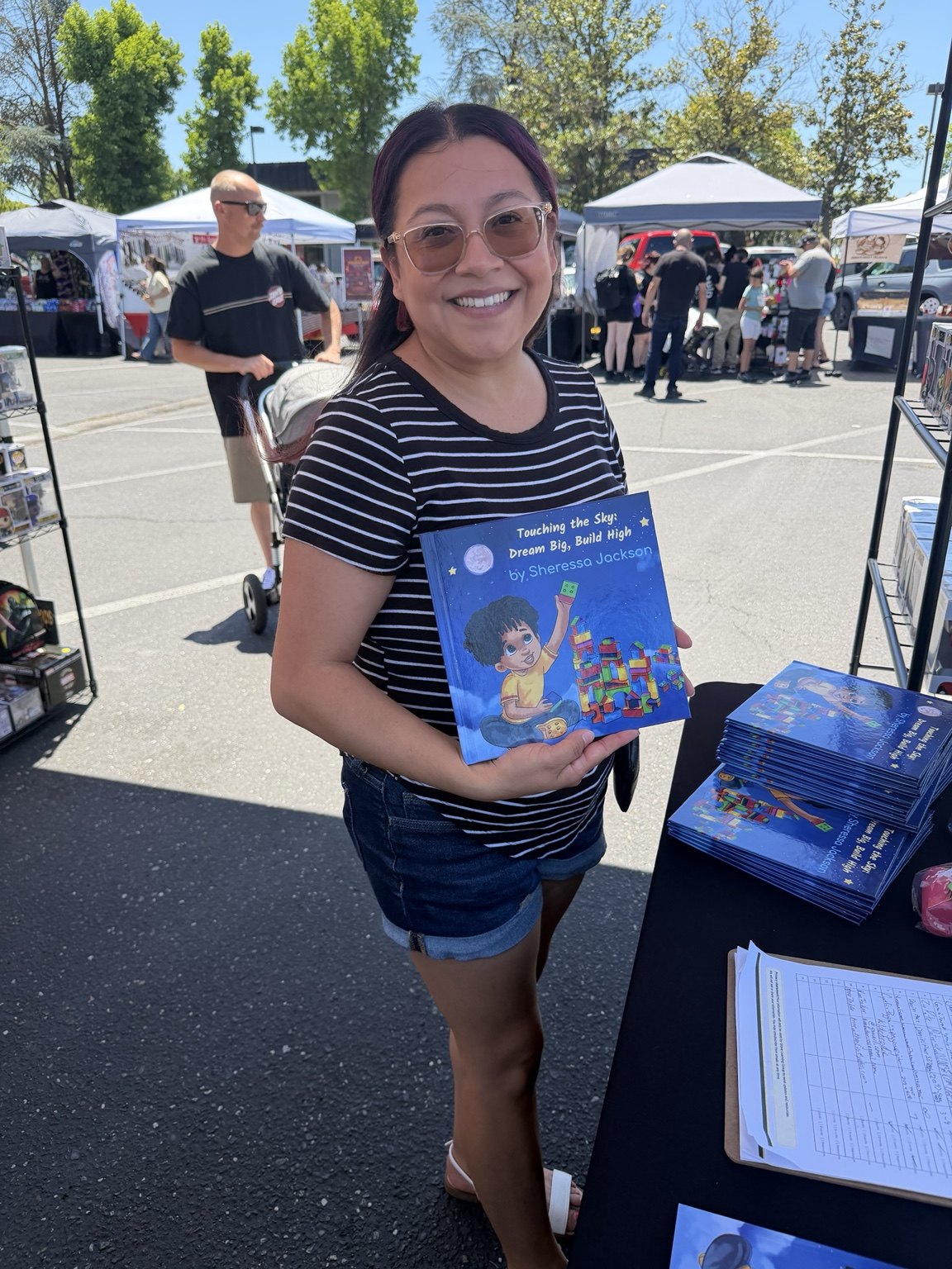 Reader with Touching the Sky at a pop-up event